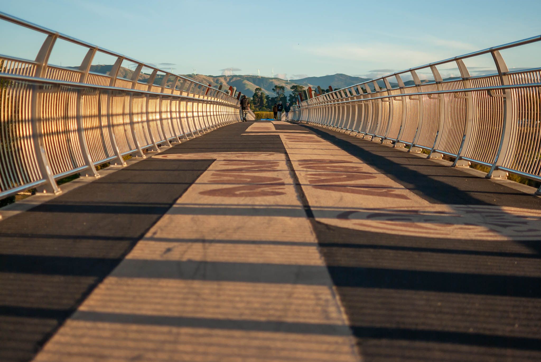 A shot of a bridge with people in the distance