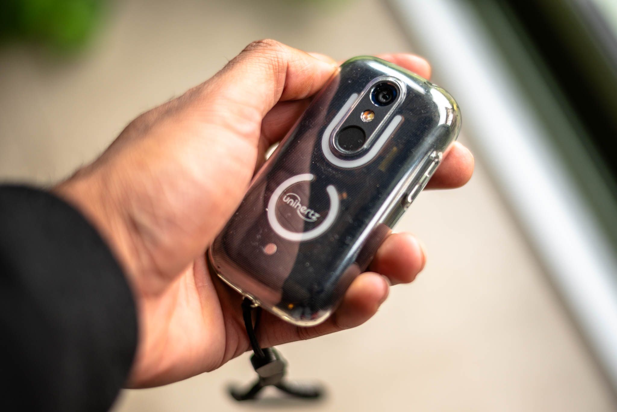 Holding a small smartphone showing the back