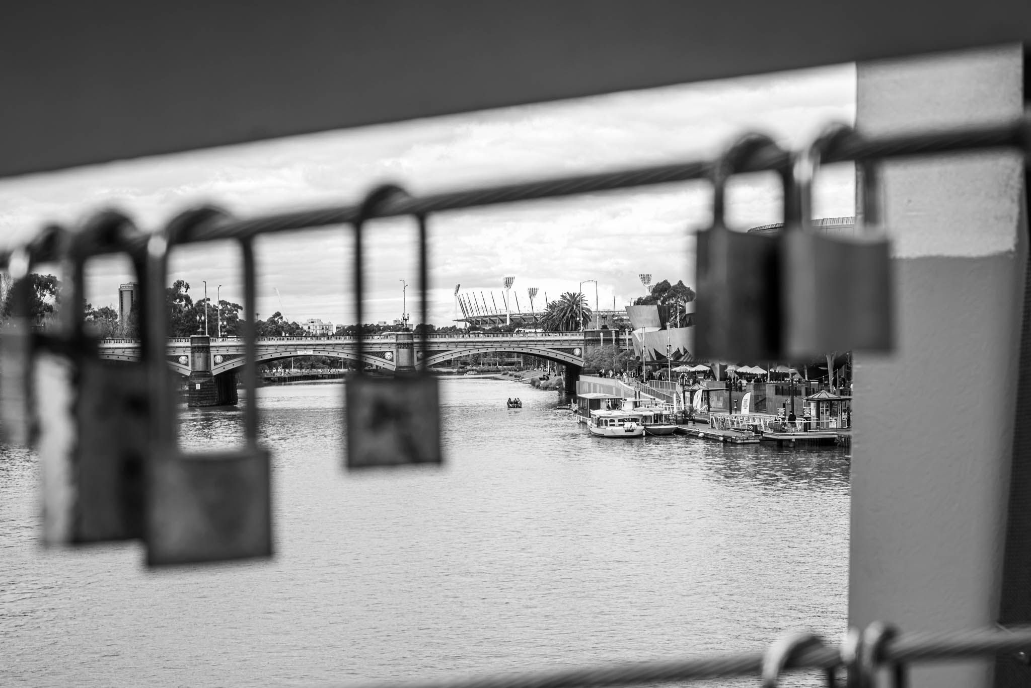 Locks in the foreground with the MCG stadium in the distance
